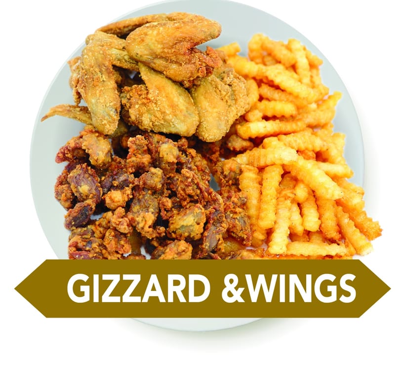 Plate of crispy fried chicken wings, gizzards, and crinkle-cut fries.